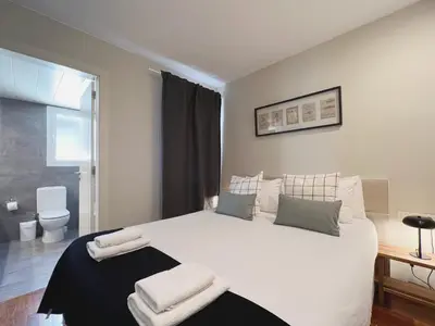 a bedroom with a large white bed with towels on it at Stay U-nique Apartments Sants II in Barcelona