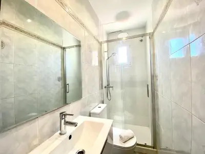 a white bathroom with a sink and a shower at Sants Montjuic Olympic View in Barcelona