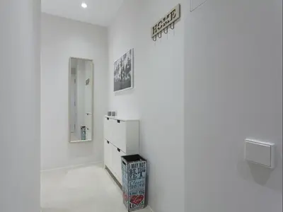 a white room with white walls and a sign on the wall at Sunny Playa Apartment in Barcelona