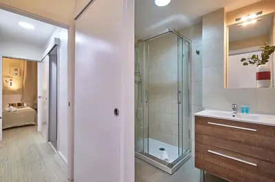 a bathroom with a glass shower and a sink at BBarcelona Modern Eixample Flat in Barcelona