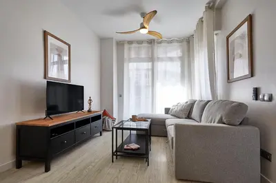 a living room with a couch and a flat screen tv at BBarcelona Modern Eixample Flat in Barcelona