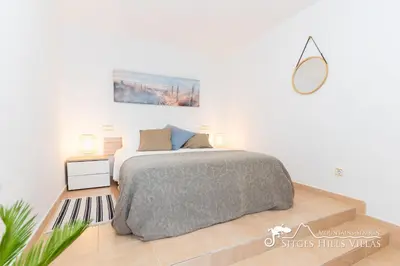 a white bedroom with a bed and a window at Charming Spanish Villa private pool / Sea views in Sitges