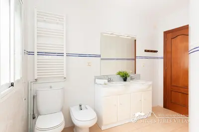 a bedroom with a bed and a painting on the wall at Charming Spanish Villa private pool / Sea views in Sitges