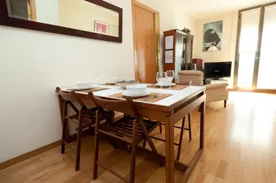 a dining room with a table and some chairs at Penthouse Vallespir in Barcelona