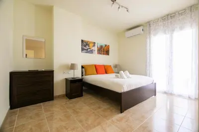 a bedroom with a bed and a dresser at Be Barcelona Eixample Urquinaona II in Barcelona