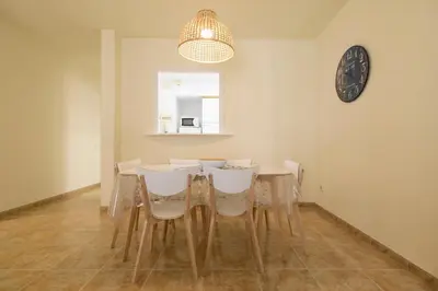 a dining room with a table and white chairs at Be Barcelona Eixample Urquinaona II in Barcelona