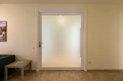 a white door in a room with a table at Be Barcelona Eixample Urquinaona II in Barcelona