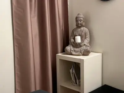 a statue sitting on a table with a candle at Nice apartment close PARK GÜELL 2 in Barcelona