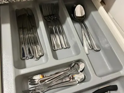 a drawer filled with silver utensils and spoons at Nice apartment close PARK GÜELL 2 in Barcelona