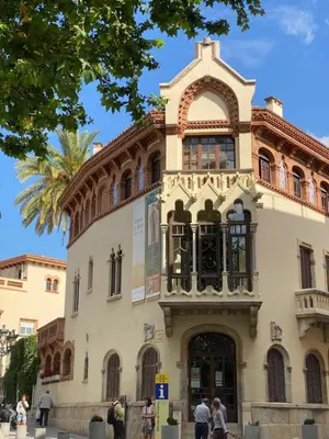 a building with people standing outside of it at Luminoso apartamento en Canet de Mar cercano a la playa y a Barcelona in Canet de Mar