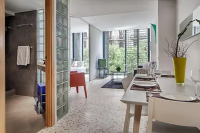 a kitchen and dining room with a table and chairs at Habitat Apartments Pedrera in Barcelona