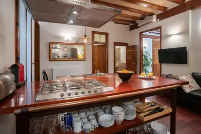 a kitchen with a stove and a counter top at Habitat Apartments Ferran in Barcelona