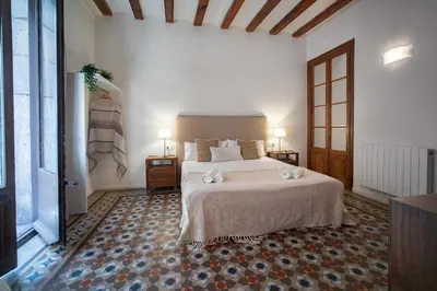 a bedroom with a white bed with two towels on it at Habitat Apartments Ferran in Barcelona