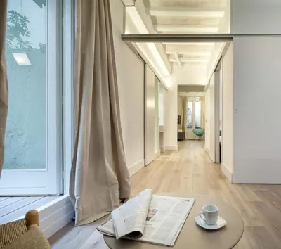a living room with a table and a window at Habitat Apartments Born in Barcelona