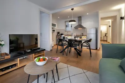 a living room with a couch and a table with a bowl of fruit at Habitat Apartments Art in Barcelona
