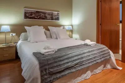 a bedroom with a large bed with towels on it at Habitat Apartments Carders in Barcelona