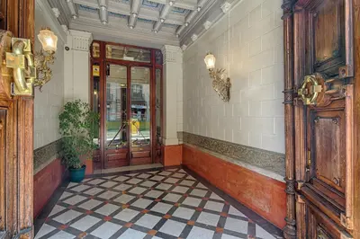 a hallway with a door and a tile floor at Habitat apartments Barcelona Center in Barcelona