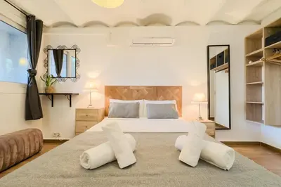 a bedroom with a large bed with two white pillows at Cozy Place next to Park Güell in Barcelona
