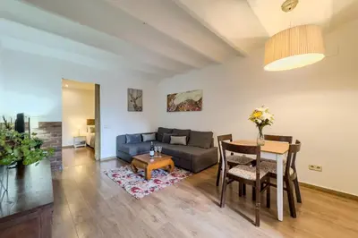 a living room with a couch and a table at Cozy Place next to Park Güell in Barcelona