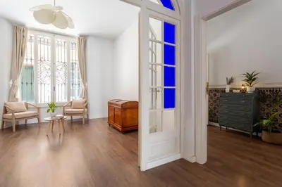 a living room with a door and a table and chairs at Divino Hotel Boutique in Sitges