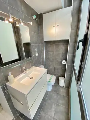 a bathroom with a white sink and a toilet at True Design in Heart of Noble BCN in Barcelona