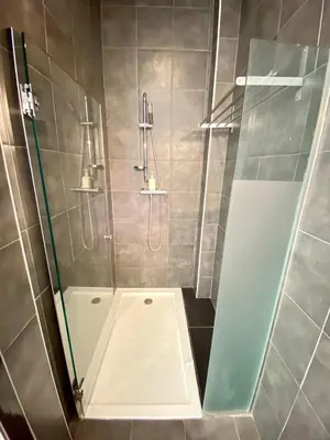a shower with a glass door in a bathroom at True Design in Heart of Noble BCN in Barcelona