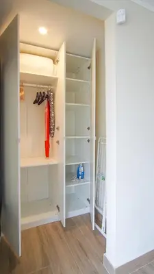 a walk in closet with white shelves at Holidays en Arenys de Mar y Montaña in Arenys de Mar
