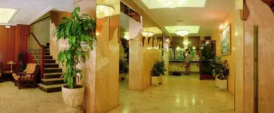 a lobby with a staircase and plants in it at HOTEL CONTINENTAL in Calella