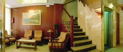 a lobby with a staircase and a stair case at HOTEL CONTINENTAL in Calella