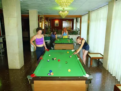 a group of people standing around a pool table at HOTEL CONTINENTAL in Calella