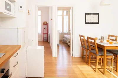 a kitchen and dining room with a table and a bed at Barcelona cozy apartment in Barcelona