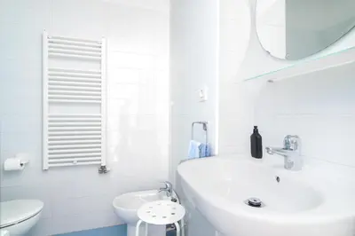a white bathroom with a sink and a toilet at Barcelona cozy apartment in Barcelona