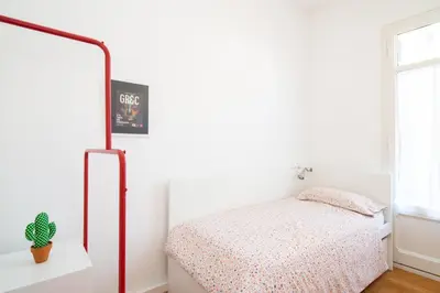 a bedroom with a bed and a white wall at Barcelona cozy apartment in Barcelona
