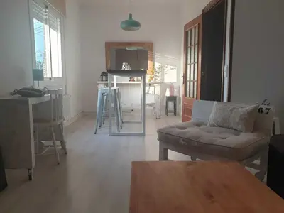 a living room with a couch and a table at SITGES Apartment PALLARÉS in Sitges