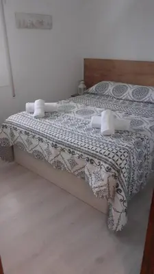 a bedroom with a bed with a white bedspread at SITGES Apartment PALLARÉS in Sitges