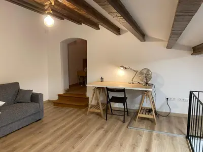 a living room with a table and a couch at Masia Can Llonch in Palau-Solità i Plegamans