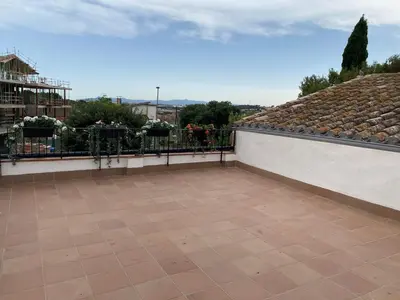 a balcony with a fence and a tile floor at Masia Can Llonch in Palau-Solità i Plegamans