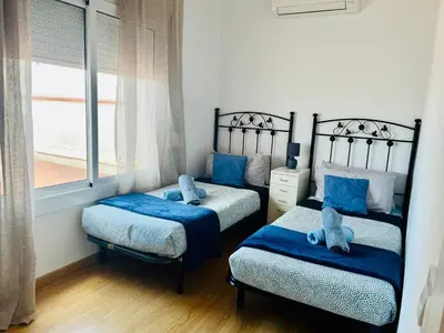 a bedroom with two twin beds and a window at Attic360Views in Barcelona