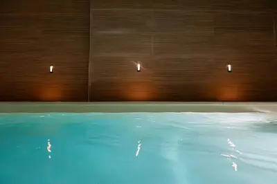 a bedroom with a bed and a bathroom with a shower at The Collection Barcelona - Amazing 3 Bedroom Apartment with indoor POOL in Barcelona
