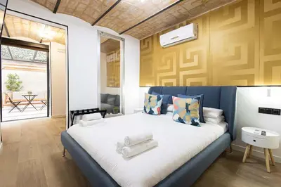 a living room with a couch and a bed at The Collection Barcelona - Amazing 3 Bedroom Apartment with indoor POOL in Barcelona