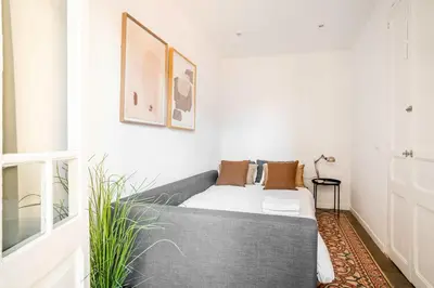 a white bedroom with a bed and a window at The Collection Barcelona - Sagrada Familia- Emblematic and Charming Catalan Home in Barcelona
