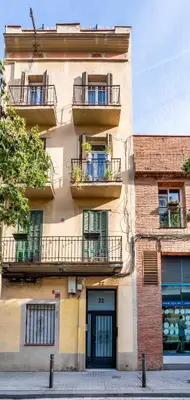 a window with potted plants on a balcony at The Collection Barcelona - Sagrada Familia- Emblematic and Charming Catalan Home in Barcelona