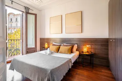 a bedroom with a bed and two lamps and a window at The Collection Barcelona - Plaza Urquinaona Cozy and comfortable in Barcelona