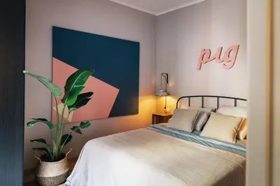 a bedroom with a bed and a painting on the wall at The Collection Barcelona - Comfortable 3-bedroom next to Sagrada Familia in Barcelona
