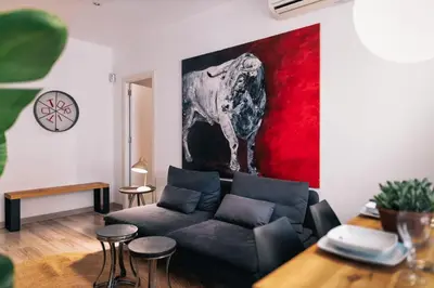 a bedroom with a bed and a chandelier at The Collection Barcelona - Comfortable 3-bedroom next to Sagrada Familia in Barcelona