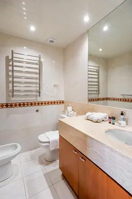 a bathroom with a sink and a toilet and a mirror at The Collection Barcelona - Elegant 3-bedroom Apartment in the Heart of BCN in Barcelona