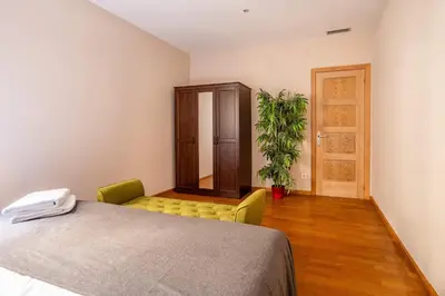 a bedroom with a bed and a potted plant at The Collection Barcelona - Elegant 3-bedroom Apartment in the Heart of BCN in Barcelona