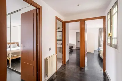 a living room with two couches and a tv at The Collection Barcelona - Amazing 3 bedroom penthouse in Plaza España in Barcelona