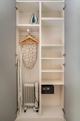 a walk in closet with white shelves and a radiator at The Collection Barcelona - Stylish and centric 2-bedroom apartment with Terrace in Eixample in Barcelona