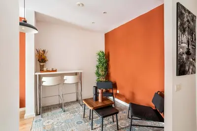 a living room with a table and chairs at The Collection Barcelona - Stylish and centric 2-bedroom apartment with Terrace in Eixample in Barcelona